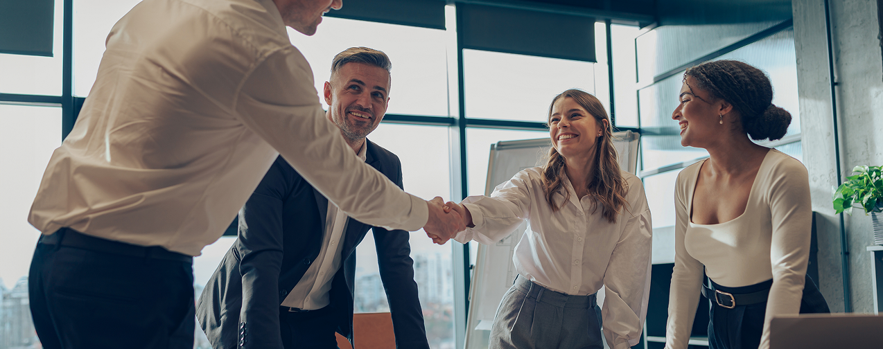 two-business-people-shaking-hands-after-successful-partnership-negotiation-meeting-room 1
